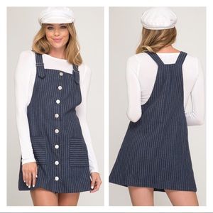 Navy color mini skirt overall. Adjustable strap.